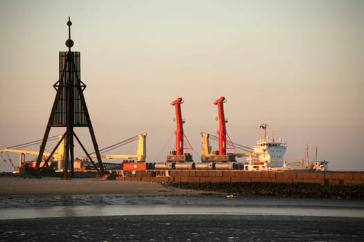 Cargo ship behind the Kugelbake,the landmark of Cuxhaven on the North Sea