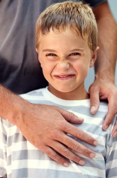 Funny, face and portrait of child with parent playing for bonding, support and love in outdoor park together. Care, cute and young kid happy hug father or dad on vacation or holiday travel with smile.