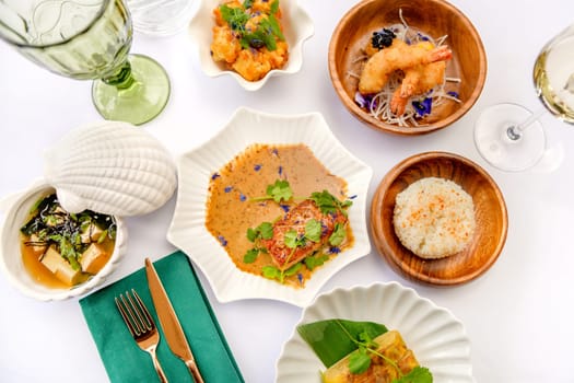 Set of Japanese dishes: miso soup, tamago, tempura shrimp, rice isolated