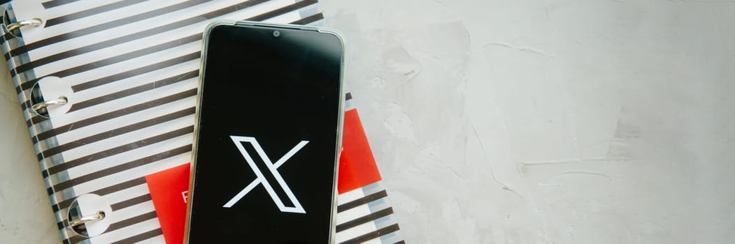 July 25, 2023, Russia. The logo in the form of the letter X displayed on the smartphone. Twitter rebranding, and implementation of X