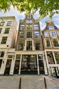 some very old buildings in amsterdam, the sky is blue and there are many windows that look like they're
