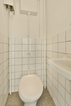 a white toilet in a bathroom with tile on the floor and walls, it is very nice to look at