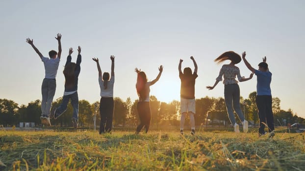 Merry friends bouncing around at sunset