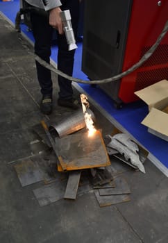 Laser metal cleaning. A man using laser metal cleaning machine to clean a metal surface from rust. Worker cleaning metal from coating by laser. Steel laser clean technologies. New modern technology