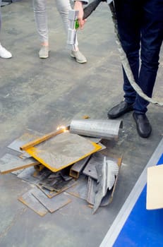 Laser metal cleaning. A man using laser metal cleaning machine to clean a metal surface from rust. Worker cleaning metal from coating by laser. Steel laser clean technologies. New modern technology