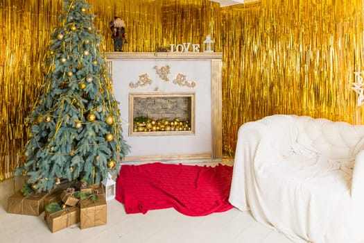 Photo of luxury gift boxes under Christmas tree, New Year home decorations, golden wrapping of Santa presents