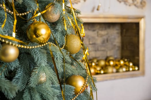Photo of luxury gift boxes under Christmas tree, New Year home decorations, golden wrapping of Santa presents