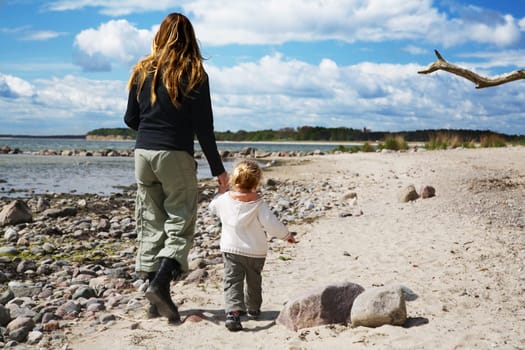 Mother and child walking on the beach