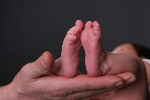 Baby feet on hand