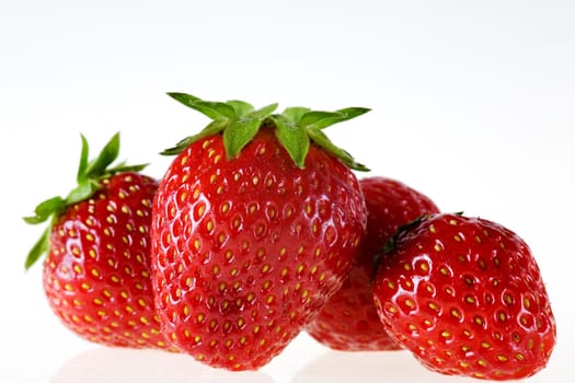 Several strawberries against a white background
