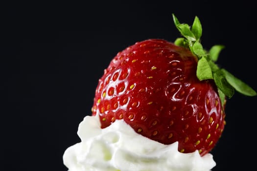 A strawberry on top of the icing