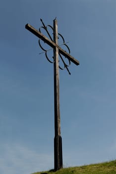 Mountain cross in front of a blue sky