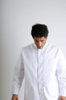 Man in white coat looking down