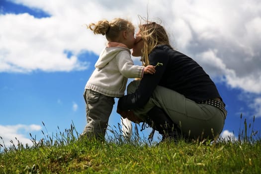 Mother and child,the child gives a kiss to the mother