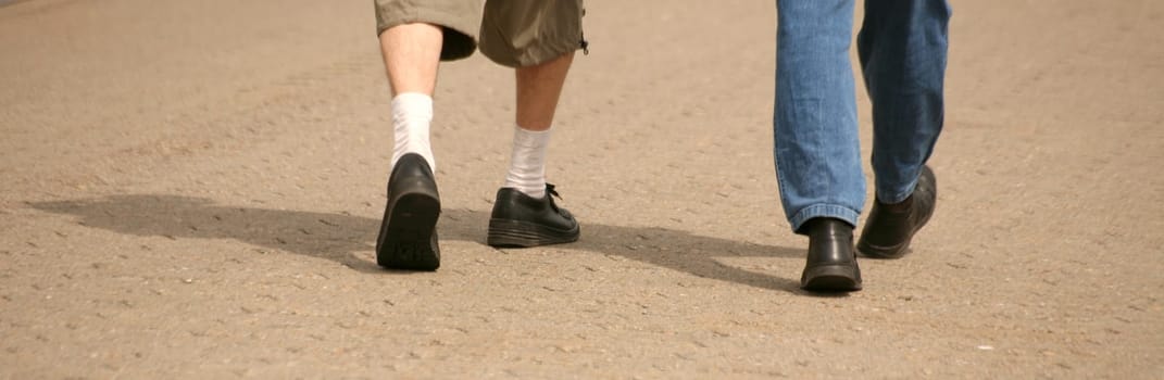 Feet of two passers-by