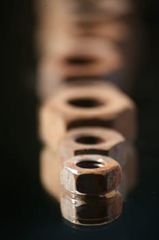Old,rusted screw nuts on a mirror