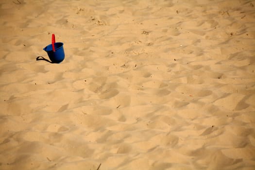 Abandoned children's toys on a sandy beach
