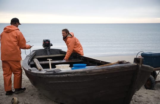 2 sailors at work on the boat