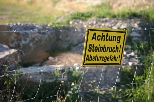 Sign on the edge of a quarry