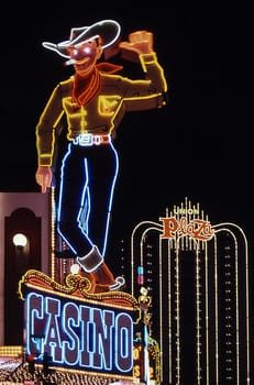 The well-known symbol of the city has stood on Fremont Street for over 50 years and waves to people. Scan of the slide