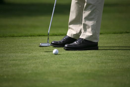 Golfers putting