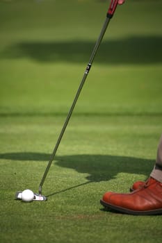 Golfers putting