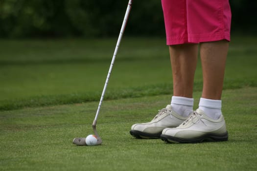 Golfers putting