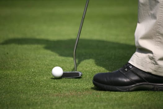 Golfers putting