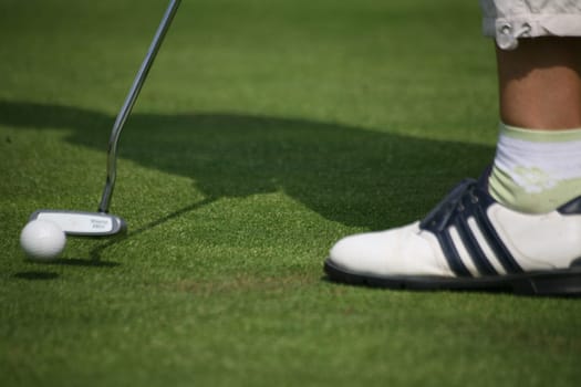 Golfers putting