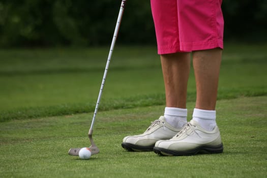 Golfers putting