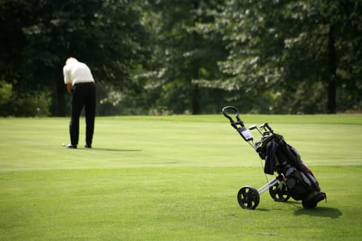 Golf trolley and golfers at a golf tournament