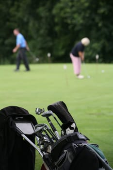 Golf trolley and golfers at a golf tournament