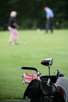 Golf trolley and golfers at a golf tournament
