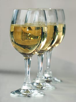 Three wine glasses offset in a row.