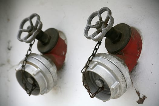 Two taps on a house wall