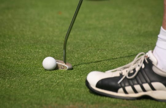 Golfers putting