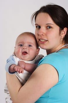 Mother holding laughing baby in her arms