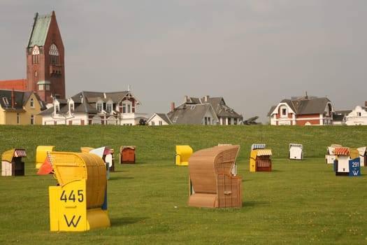 Unused beach chairs on the green beach in Grimmershörn Bay (Cuxhaven)