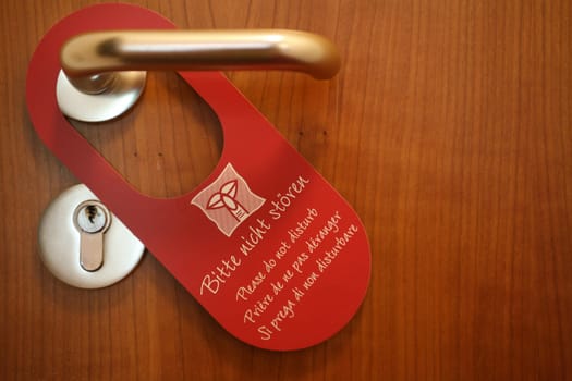 "Do Not Disturb"" sign on a hotel room door"