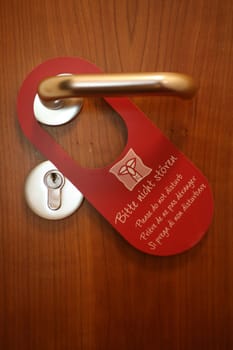 "Do Not Disturb"" sign on a hotel room door"