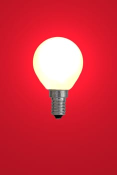Light bulb against red background