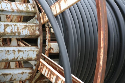 Power cable on a rusty transport drum