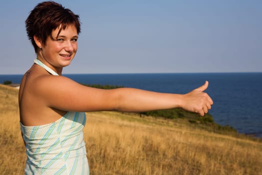a young girl with a thumbs up