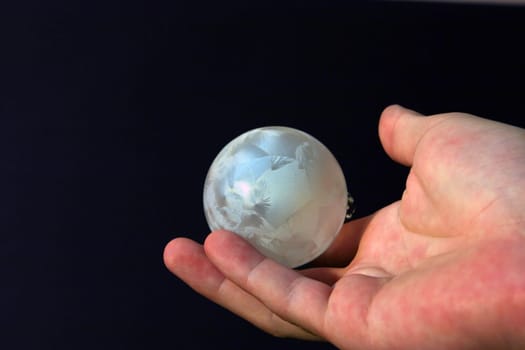 Christmas ball in hand