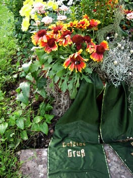 Flowers and wreaths on a grave