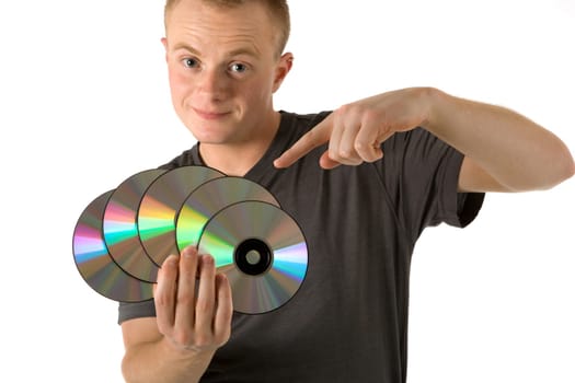 A young man with CDs in his hand,with the other he points to the CDs