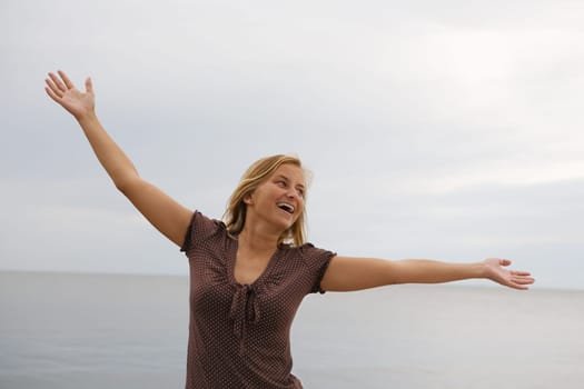 A young carefree happy woman in a jubilant pose