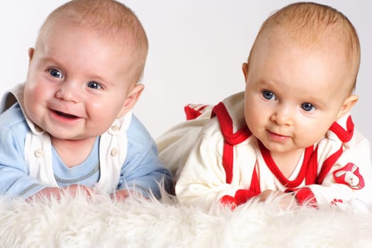 2 babies laugh and are photographed in portrait