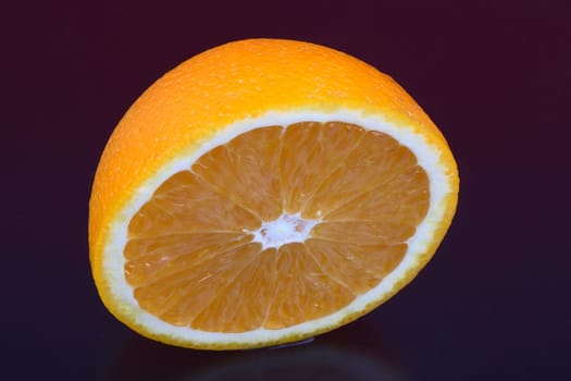 Orange and orange slices on different surfaces