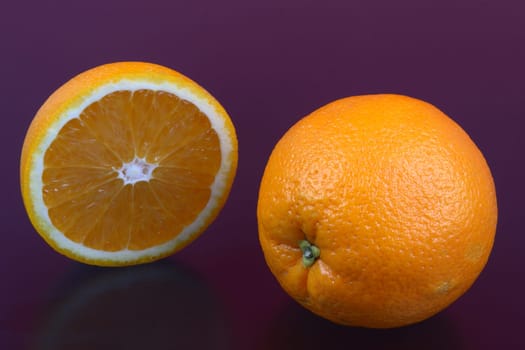 Orange and orange slices on different surfaces